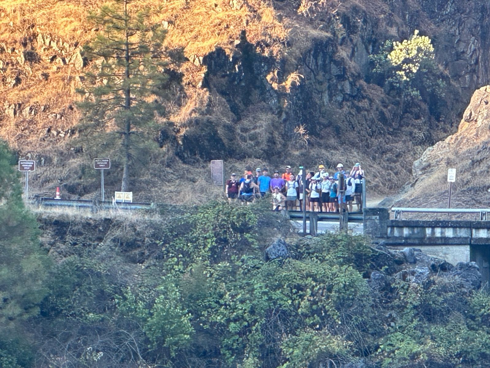 SUC runners gathered near a canyon trail bridge.